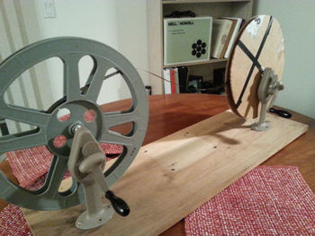 PAIR OF VINTAGE FILM WINDING ARMS AND 35MM SPLIT REELS WITH CORES