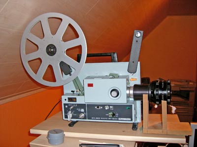 Old 8mm film projector playing in the night. Close-up of a reel with a film.  by Moon Soul. Photo stock - StudioNow