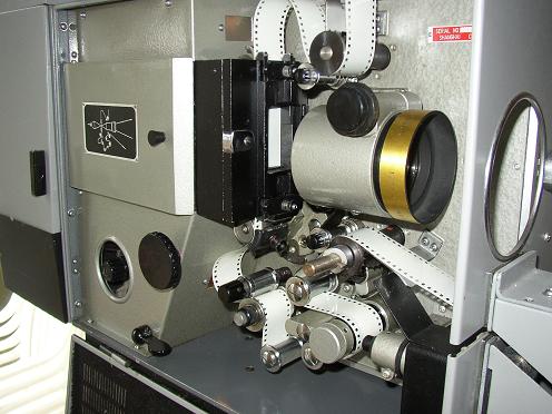 35 mm movie cinema projector detail with spool and film running