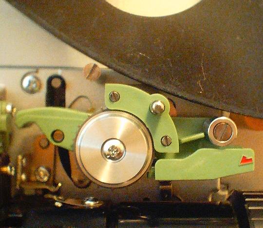 Old 8mm film projector playing in the night. Close-up of a reel